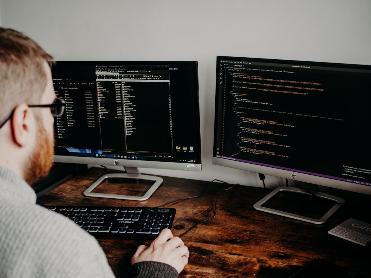 hero-02 Software developer working on code with dual monitors in a home office setting.